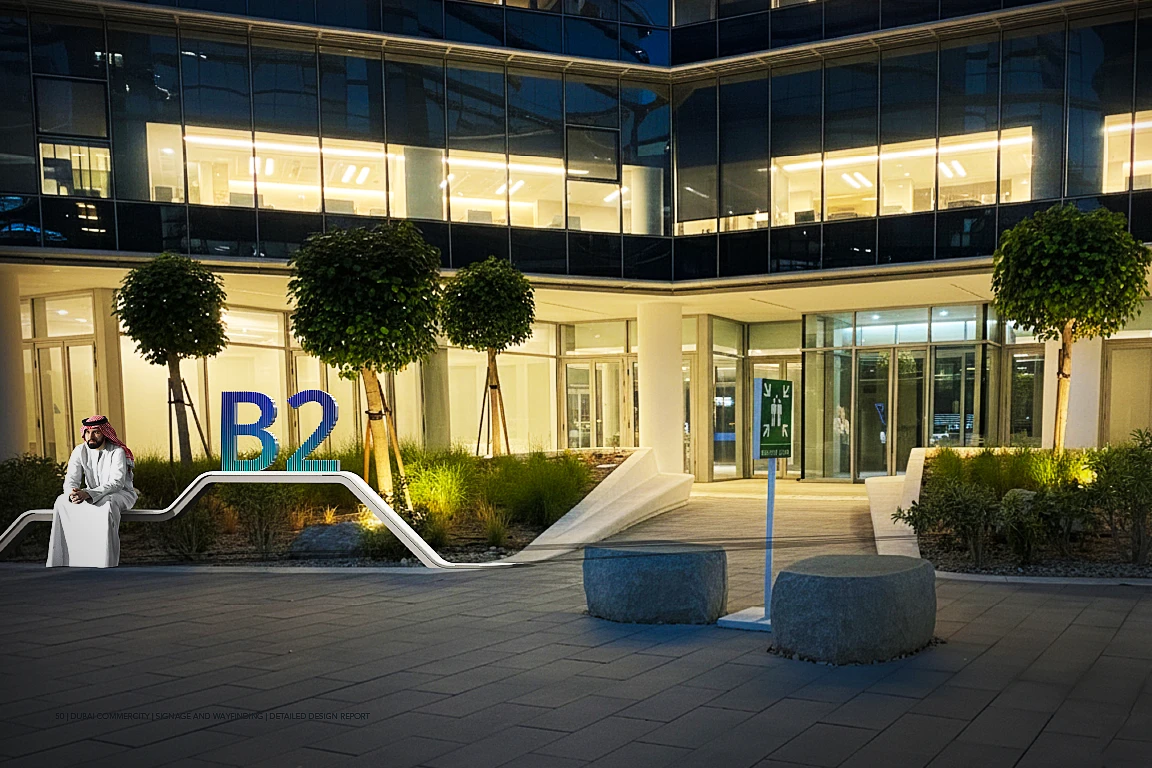 Sculptural B2 building identification marker and bench at an entrance plaza